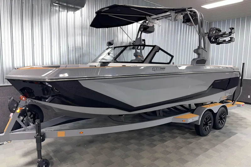 Slide: The Image of 2026 Nautique Super Air Nautique GS22 boat on trailer in showroom. - 34
