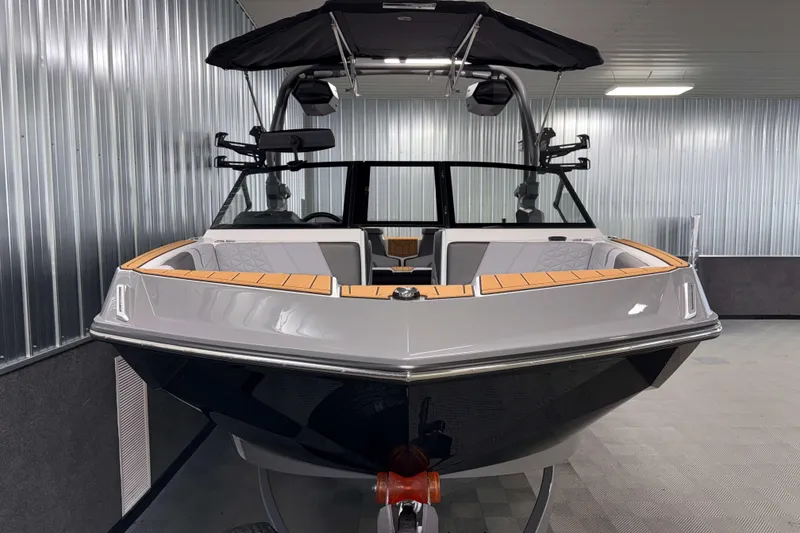 Slide: The Image of 2026 Nautique Super Air Nautique GS22 boat in a modern indoor showroom. - 35