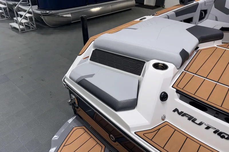 Slide: The Image of 2026 Nautique Super Air Nautique GS22 boat interior with sleek seating and teak flooring. - 4
