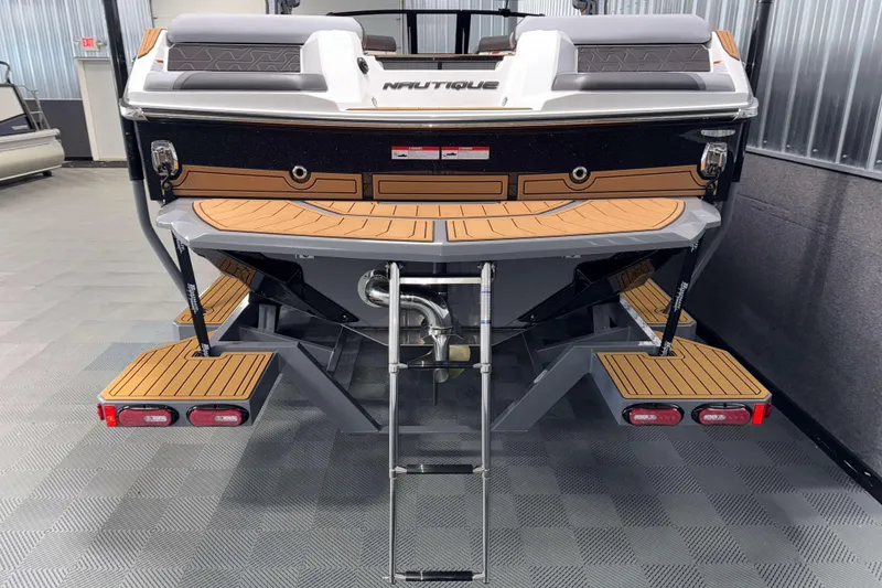 Slide: The Image of 2026 Nautique Super Air Nautique GS22 boat rear view with swim platform and ladder. - 40