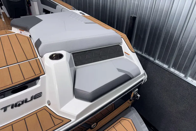 Slide: The Image of 2026 Nautique Super Air Nautique GS22 boat interior with sleek seating and wood accents. - 5