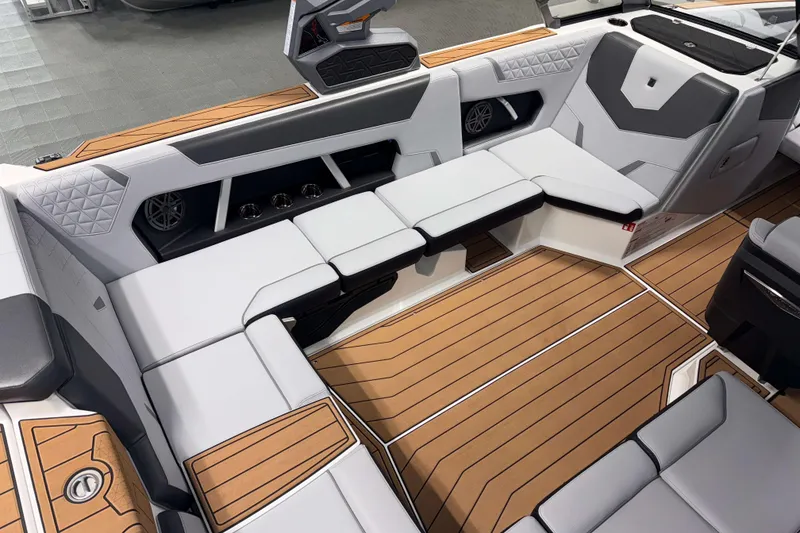 Slide: The Image of 2026 Nautique Super Air Nautique GS22 interior with luxurious seating and teak-style flooring. - 7
