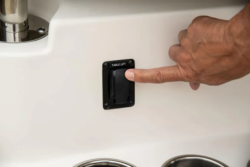 Slide: The Image of Finger pressing table lift switch on Sailfish 360 CC boat, 2022 model. - 18