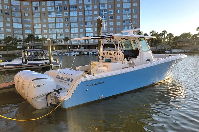 Slide: The Image of 2022 Sailfish 360 CC boat docked in marina with Yamaha engines. - 2
