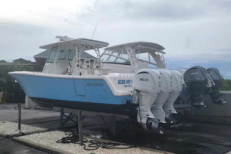Slide: The Image of 2022 Sailfish 360 CC boat with Yamaha engines on a dock. - 3