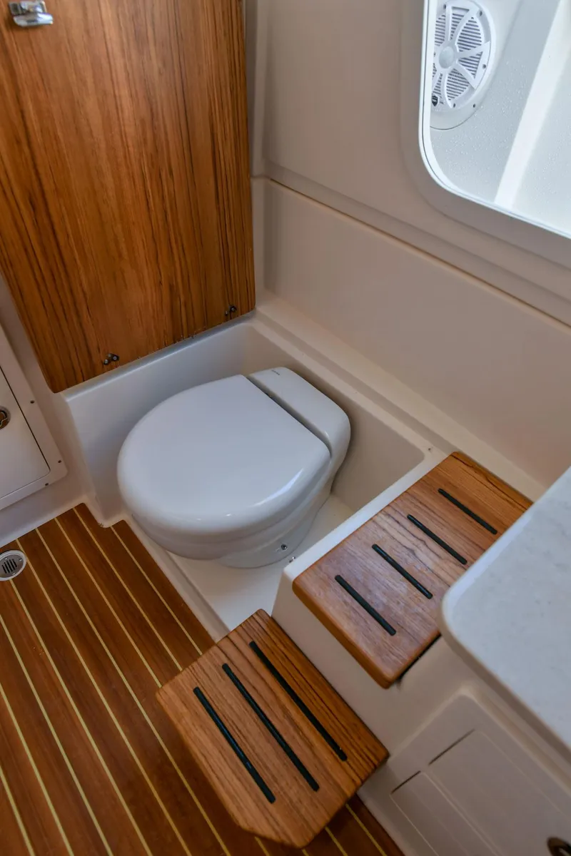 Slide: The Image of Interior of 2022 Sailfish 360 CC with toilet and wooden flooring. - 33