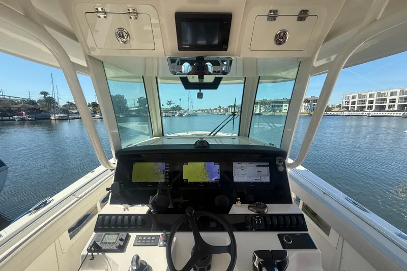 Slide: The Image of Interior view of 2022 Sailfish 360 CC boat cockpit with navigation screens. - 5