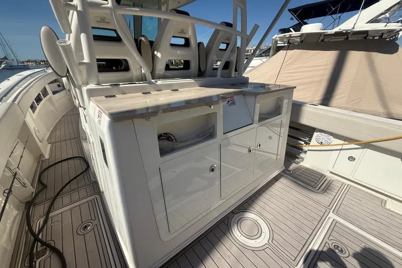Slide: The Image of 2022 Sailfish 360 CC boat deck with seating and storage compartments. - 6