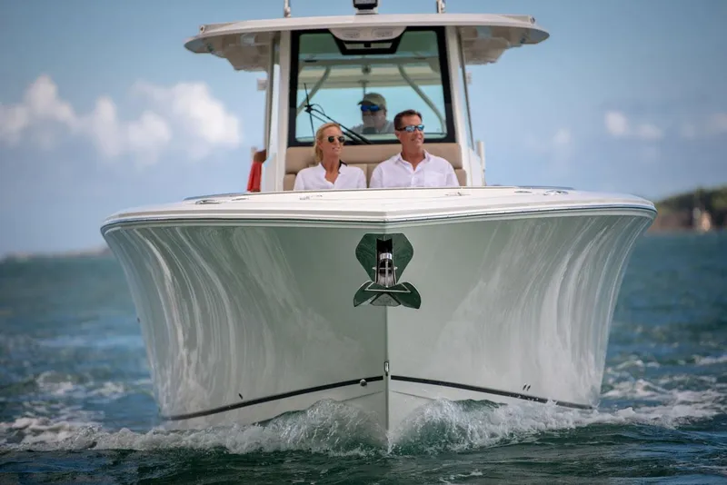 Slide: The Image of Sailfish 360 CC 2022 boat on water with two people aboard. - 8