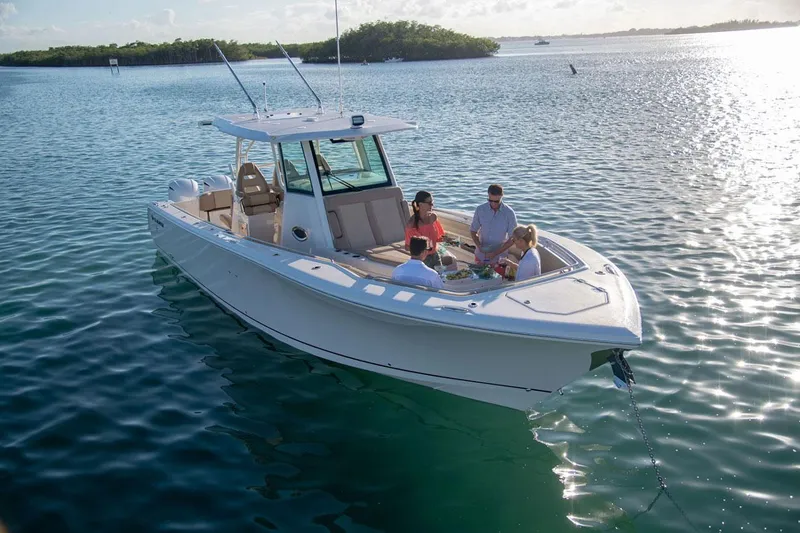 Slide: The Image of Sailfish 360 CC 2022 boat on calm water with passengers. - 9