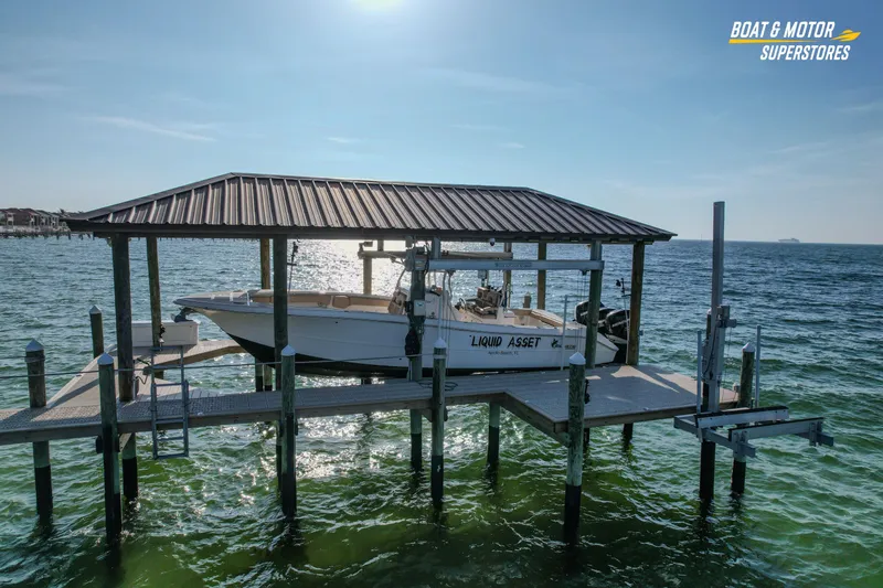 The Image of 2018 Key West Billistic 351 Center Console boat docked on a lift over water. - 0