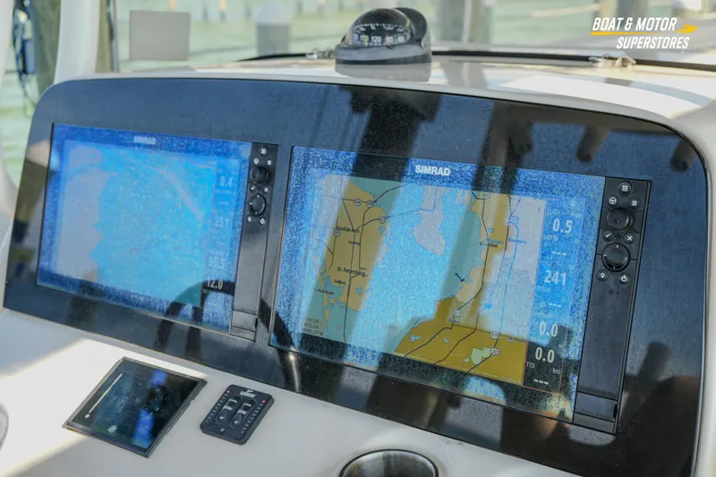 Slide: The Image of 2018 Key West Billistic 351 Center Console dashboard with dual Simrad navigation displays. - 100