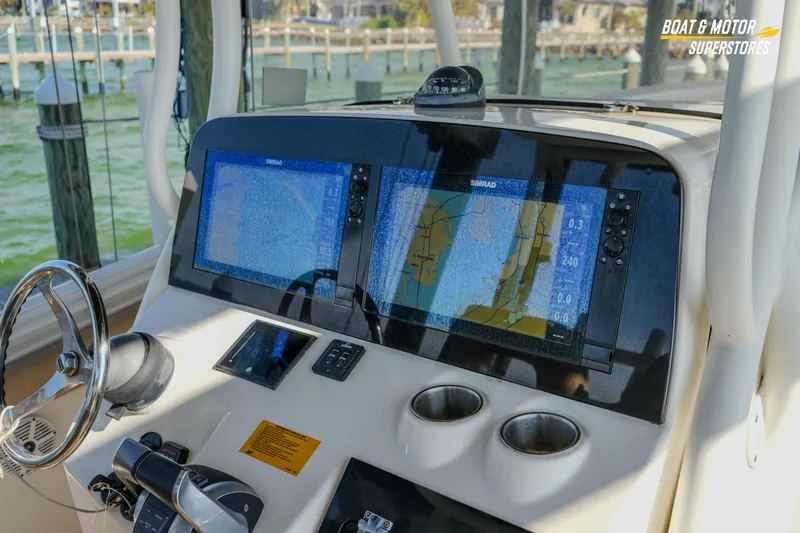 Slide: The Image of 2018 Key West Billistic 351 Center Console dashboard with navigation screens and controls. - 101