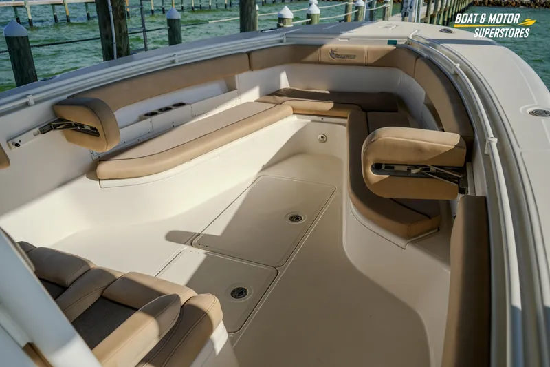 Slide: The Image of 2018 Key West Billistic 351 Center Console boat interior with tan seating and storage compartments. - 111