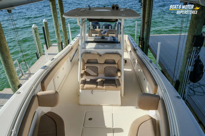 Slide: The Image of 2018 Key West Billistic 351 Center Console boat docked, showcasing spacious seating and sleek design. - 118