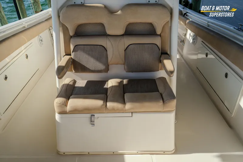 Slide: The Image of 2018 Key West Billistic 351 Center Console seating area with cushioned seats and storage. - 119