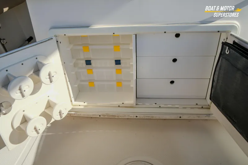 Slide: The Image of 2018 Key West Billistic 351 Center Console storage compartments and cup holders. - 127