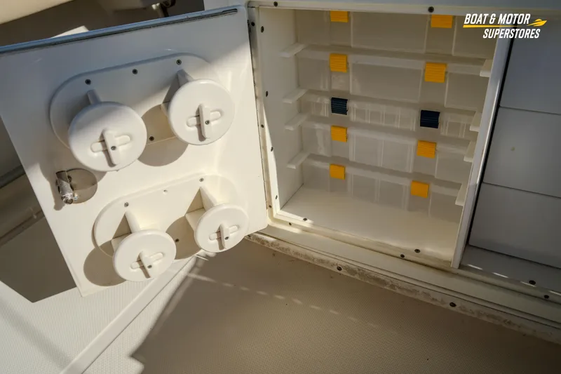 Slide: The Image of 2018 Key West Billistic 351 Center Console storage compartment with rod holders and tackle storage. - 128