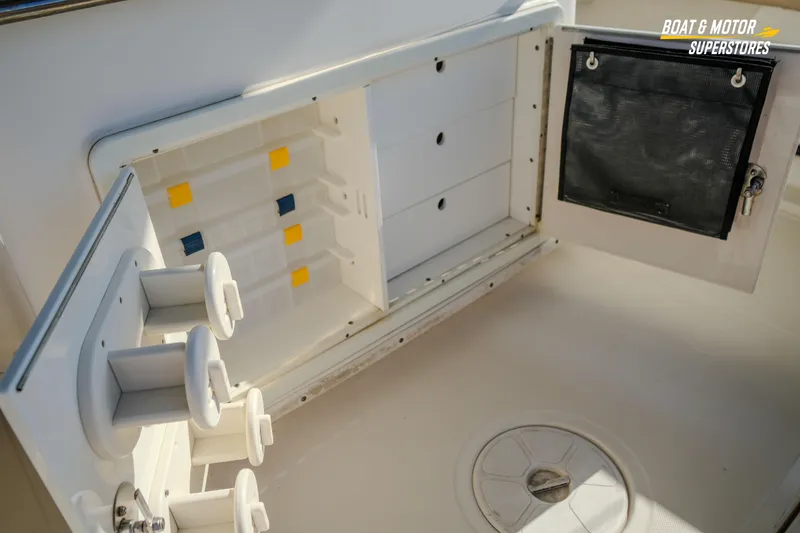 Slide: The Image of 2018 Key West Billistic 351 Center Console storage compartment with rod holders and tackle storage. - 130