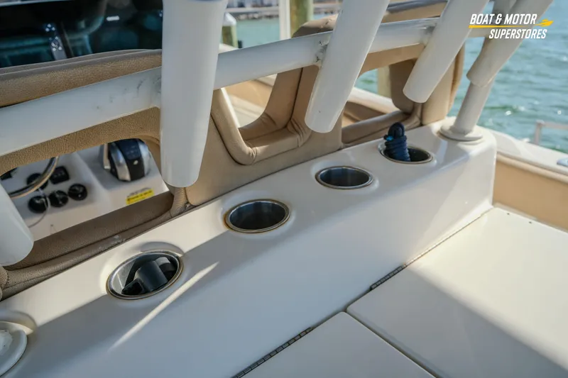 Slide: The Image of 2018 Key West Billistic 351 Center Console boat interior with cup holders and rod holders. - 134