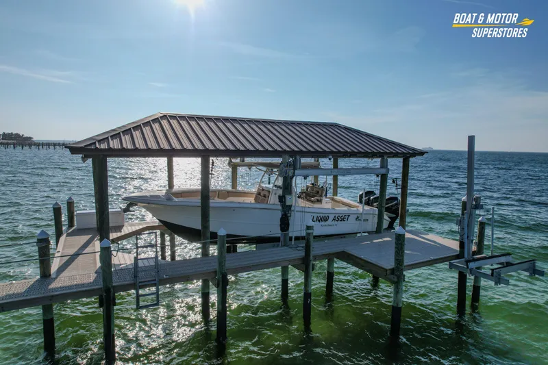 Slide: The Image of 2018 Key West Billistic 351 Center Console on docked lift over water. - 14