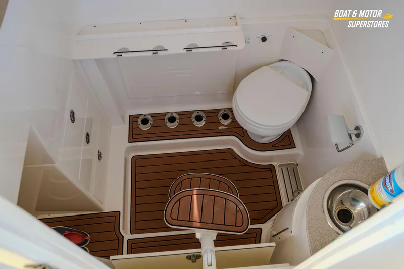Slide: The Image of 2018 Key West Billistic 351 Center Console boat bathroom with wooden flooring and compact amenities. - 141