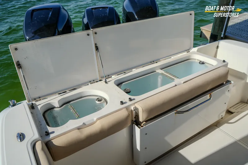 Slide: The Image of 2018 Key West Billistic 351 Center Console with open storage compartments and triple outboard motors. - 148