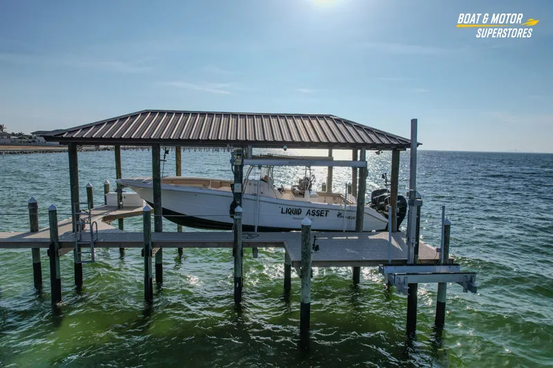 Slide: The Image of 2018 Key West Billistic 351 Center Console boat docked on a lift over water. - 15