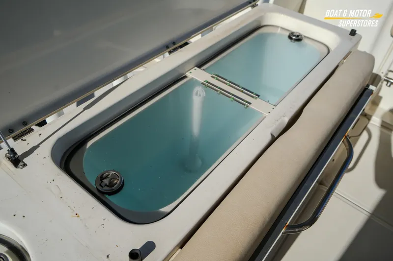 Slide: The Image of 2018 Key West Billistic 351 Center Console livewell with open lid and cushioned seating. - 150
