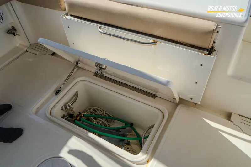 Slide: The Image of 2018 Key West Billistic 351 Center Console storage compartment with ropes and hoses. - 152