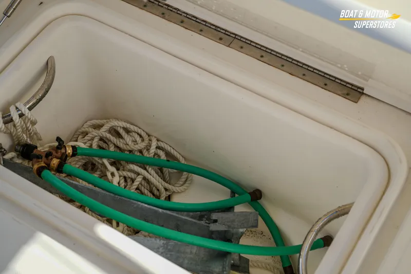 Slide: The Image of Storage compartment of 2018 Key West Billistic 351 Center Console with ropes and hoses. - 154