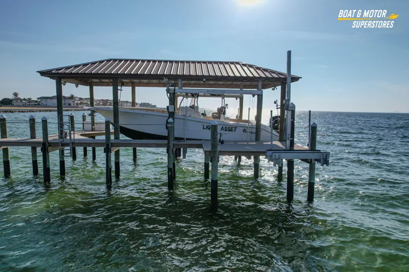 Slide: The Image of 2018 Key West Billistic 351 Center Console boat on a lift over water. - 16