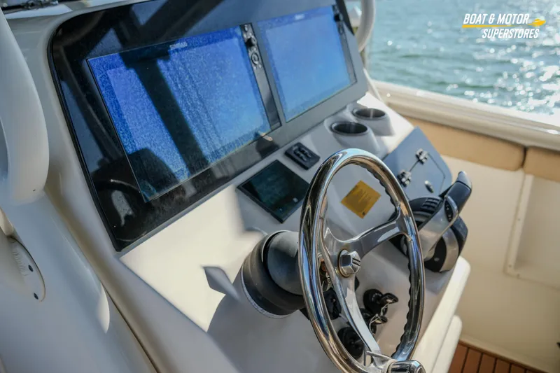Slide: The Image of 2018 Key West Billistic 351 Center Console helm with dual screens and steering wheel. - 160