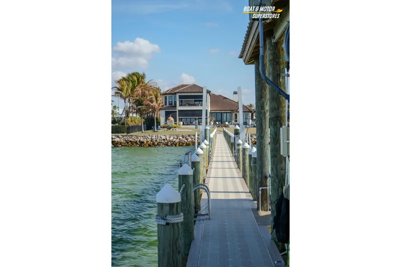 Slide: The Image of Dock leading to waterfront house, Key West Billistic 351 Center Console, 2018. - 163