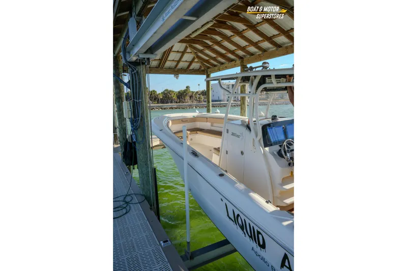 Slide: The Image of 2018 Key West Billistic 351 Center Console docked under a wooden shelter. - 165