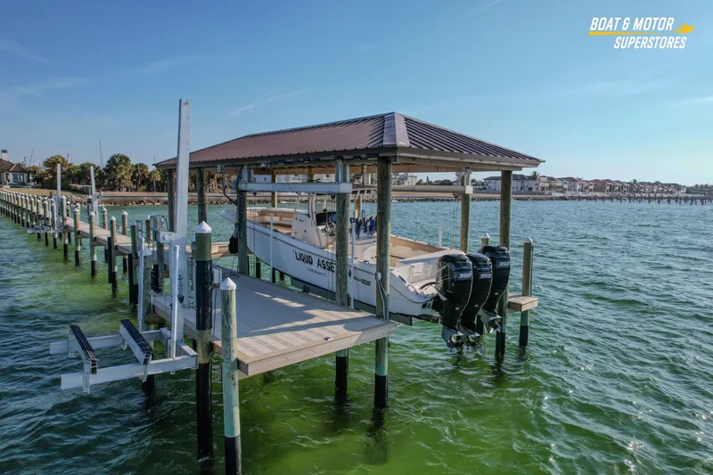 Slide: The Image of 2018 Key West Billistic 351 Center Console boat docked on a lift in a marina. - 17