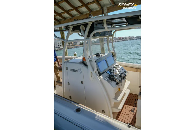 Slide: The Image of 2018 Key West Billistic 351 Center Console boat interior with steering wheel and navigation screens. - 170