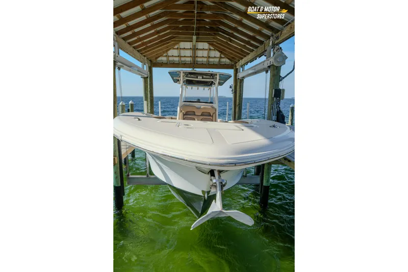 Slide: The Image of 2018 Key West Billistic 351 Center Console boat in dock, over green water. - 173