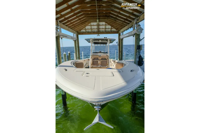 Slide: The Image of 2018 Key West Billistic 351 Center Console boat docked under a wooden shelter. - 174