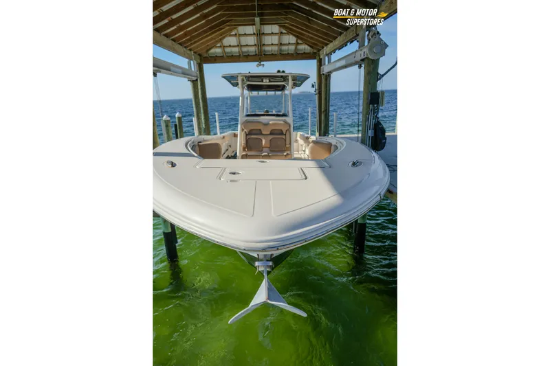 Slide: The Image of 2018 Key West Billistic 351 Center Console boat docked under a wooden shelter. - 175
