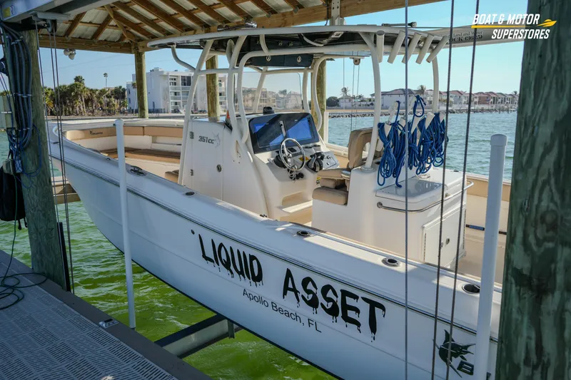 Slide: The Image of 2018 Key West Billistic 351 Center Console boat docked, featuring "Liquid Asset" name. - 181