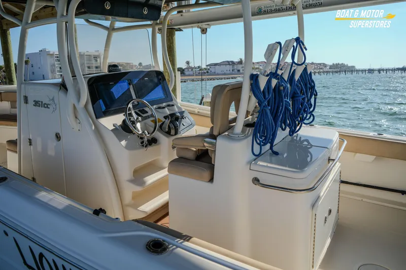 Slide: The Image of 2018 Key West Billistic 351 Center Console boat interior with steering wheel and ocean view. - 185