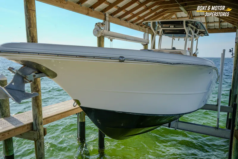 Slide: The Image of 2018 Key West Billistic 351 Center Console boat docked on lift. - 188