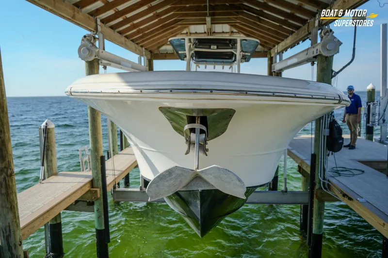 Slide: The Image of 2018 Key West Billistic 351 Center Console boat docked on a lift. - 189