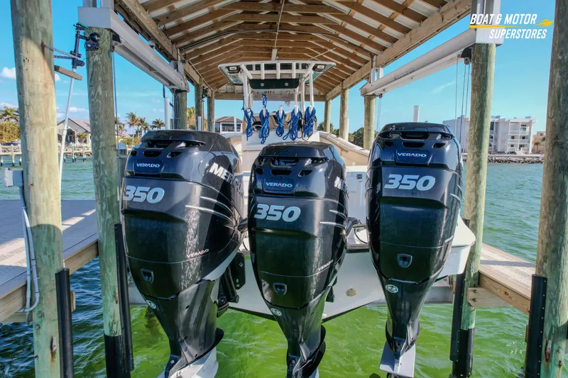 Slide: The Image of 2018 Key West Billistic 351 Center Console with triple Mercury Verado 350 engines on a lift. - 21