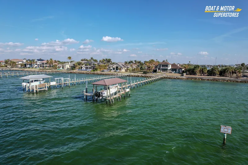 Slide: The Image of Aerial view of 2018 Key West Billistic 351 Center Console docked in a scenic waterfront area. - 24