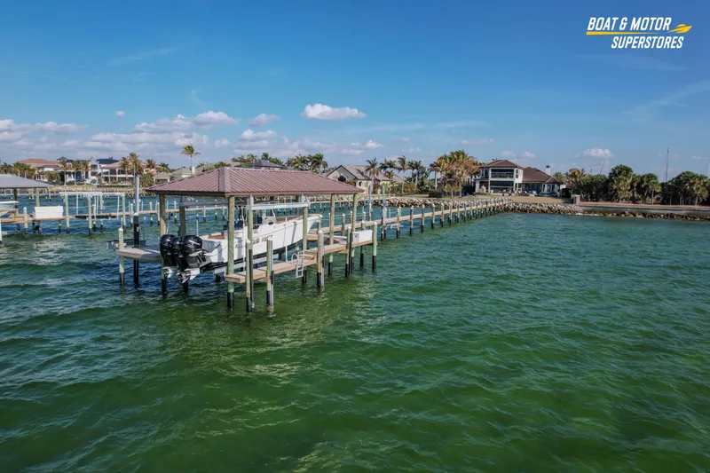 Slide: The Image of 2018 Key West Billistic 351 Center Console docked at marina with scenic waterfront view. - 26