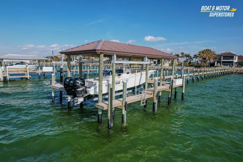 Slide: The Image of 2018 Key West Billistic 351 Center Console on dock, green water, clear sky. - 27