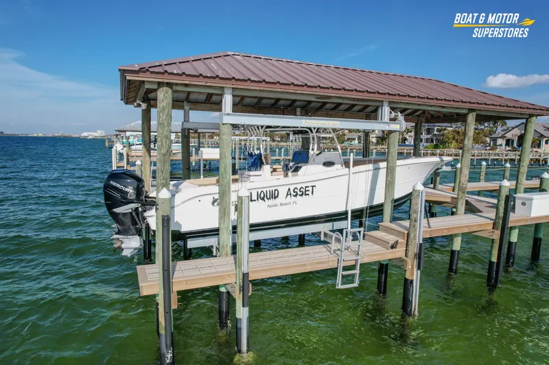 Slide: The Image of 2018 Key West Billistic 351 Center Console boat docked on a lift over water. - 28