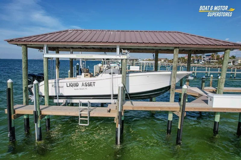 Slide: The Image of 2018 Key West Billistic 351 Center Console boat docked at marina, labeled "Liquid Asset." - 29